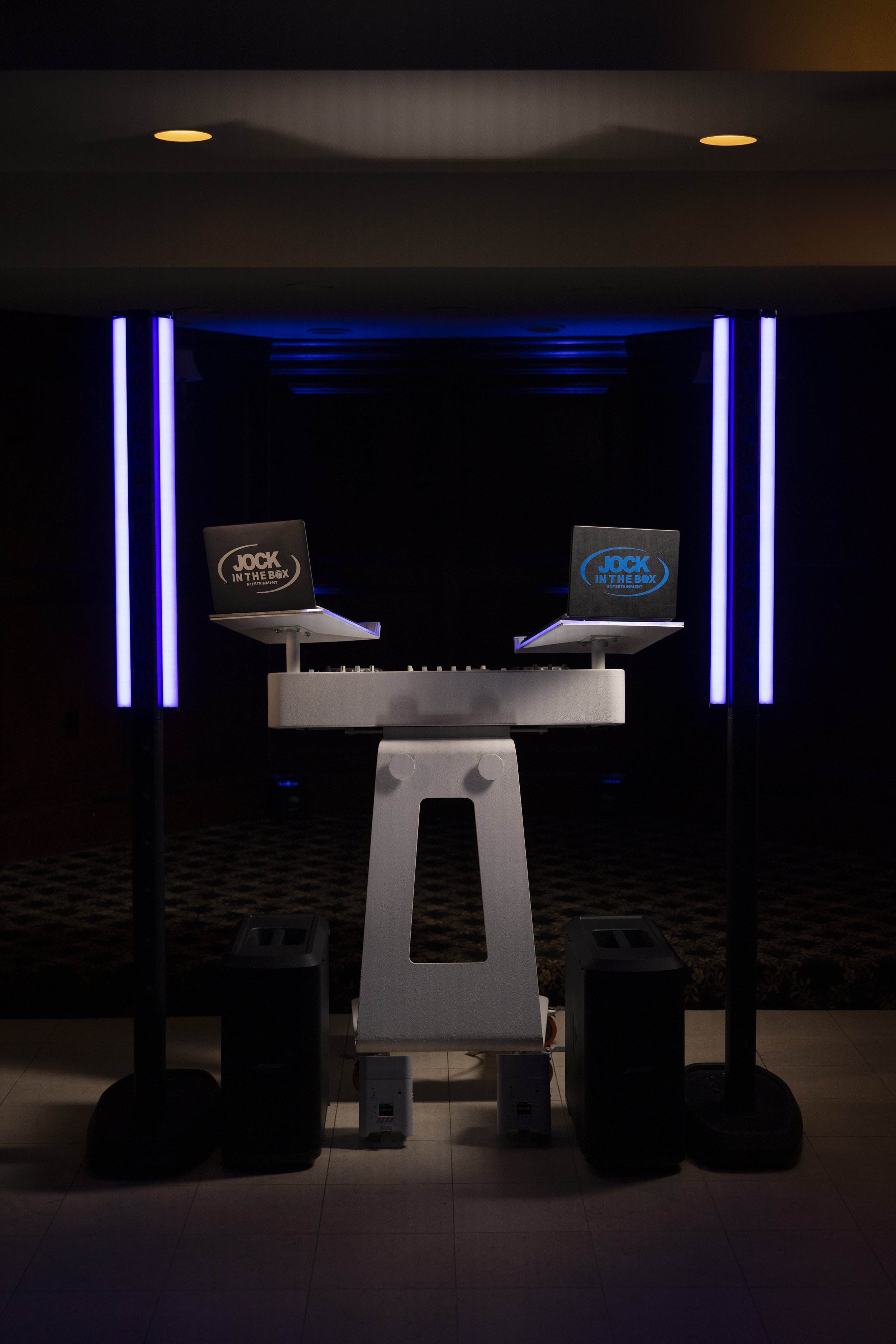 Custom Jock In The Box DJ booth glowing with signature purple tube lighting